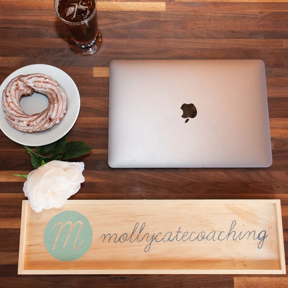Molly Cate Coaching workspace with a laptop and coffee